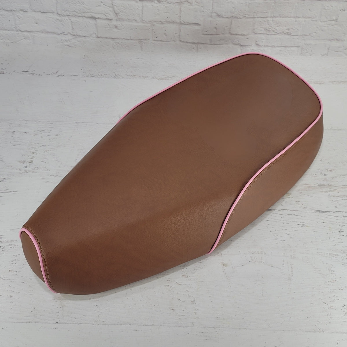 Matte cinnamon brown Genuine Buddy Kick 125 seat cover with pink piping, handmade by Cheeky Seats