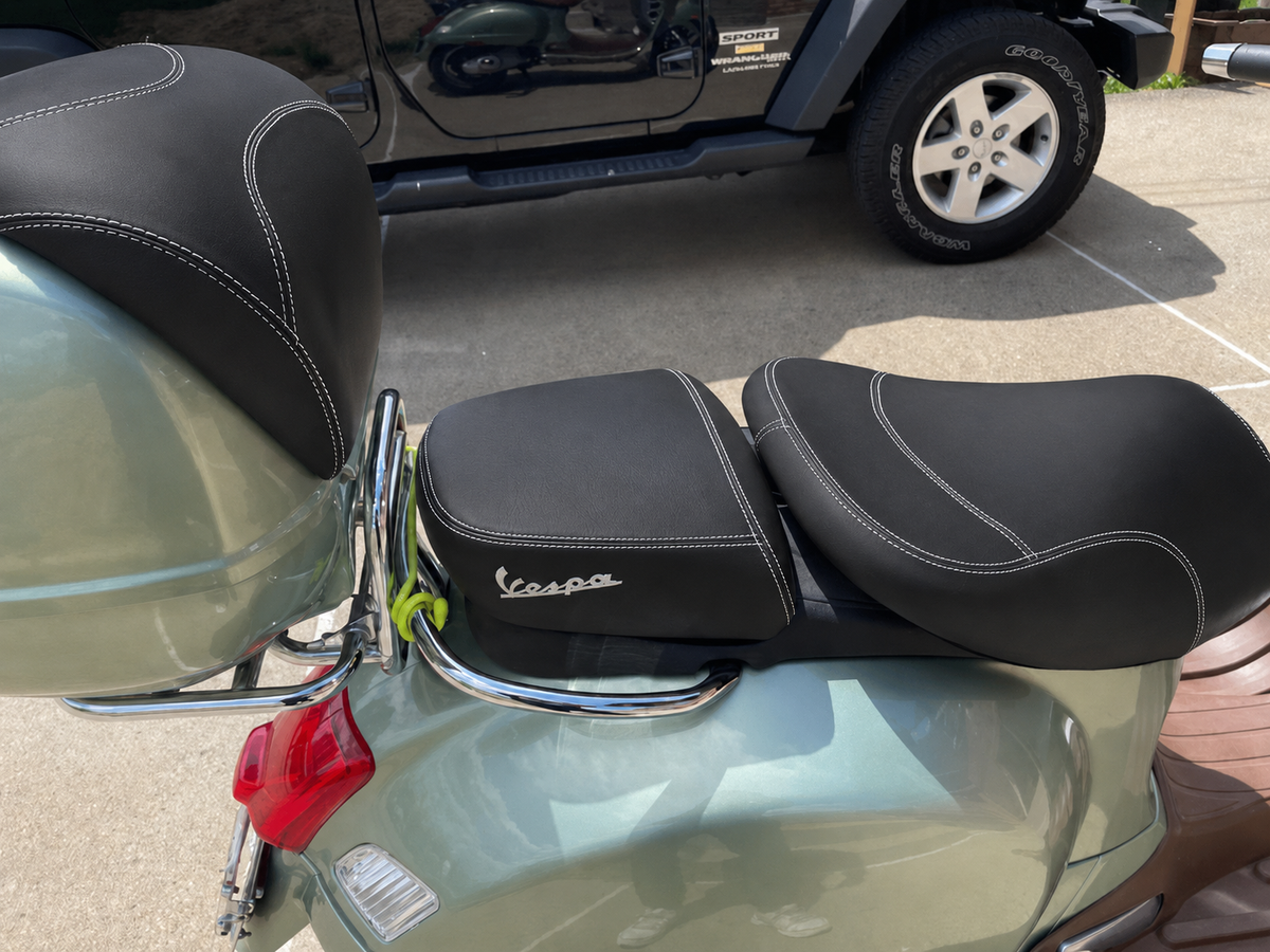 Vespa GTV black seat cover installed on scooter