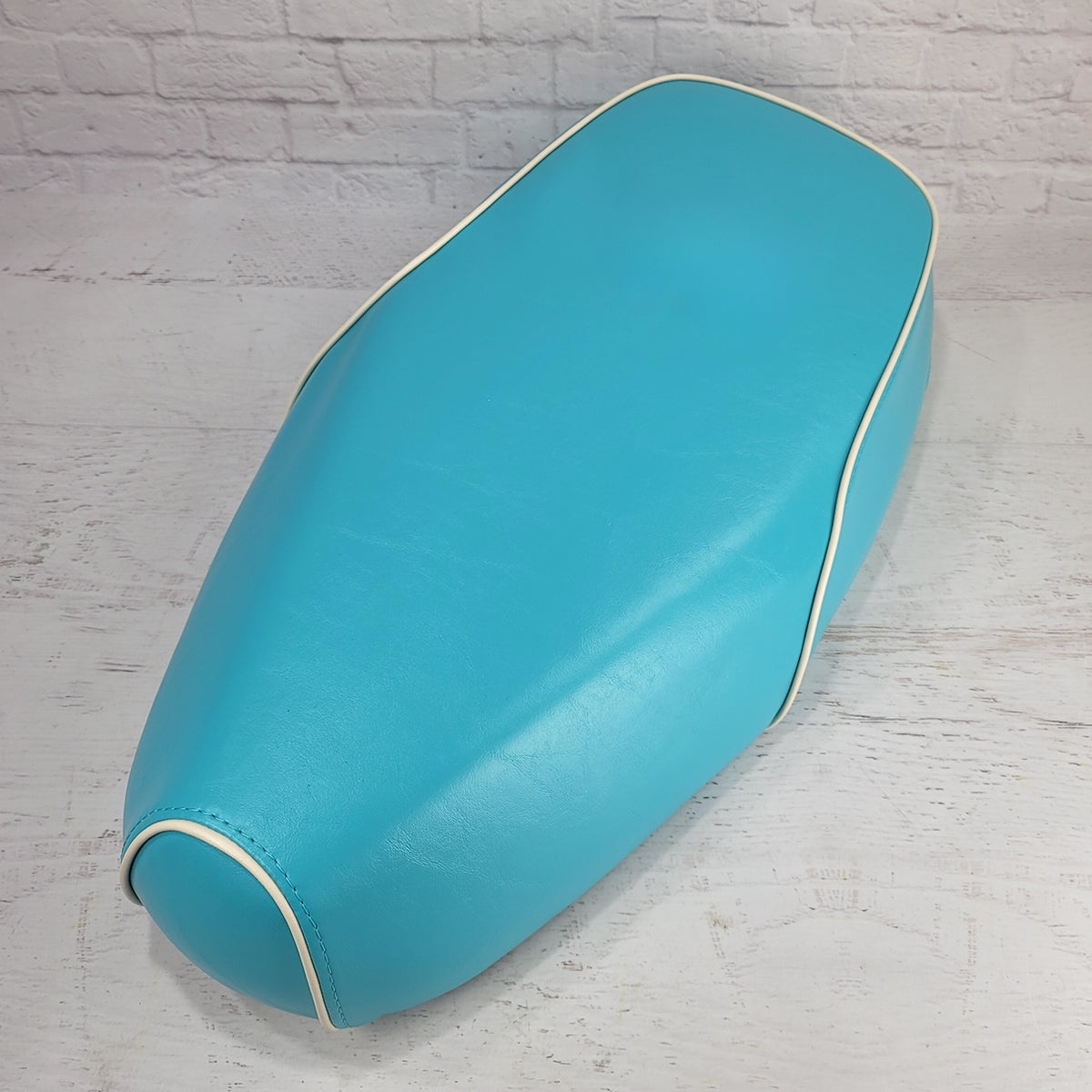 Turquoise Genuine Buddy Kick 125 seat cover with cream piping, handmade by Cheeky Seats
