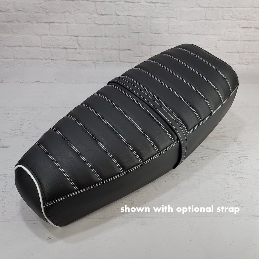 Black Cheeky Seats tuck-and-roll seat cover for the Genuine Stella, shown with white piping and an optional strap