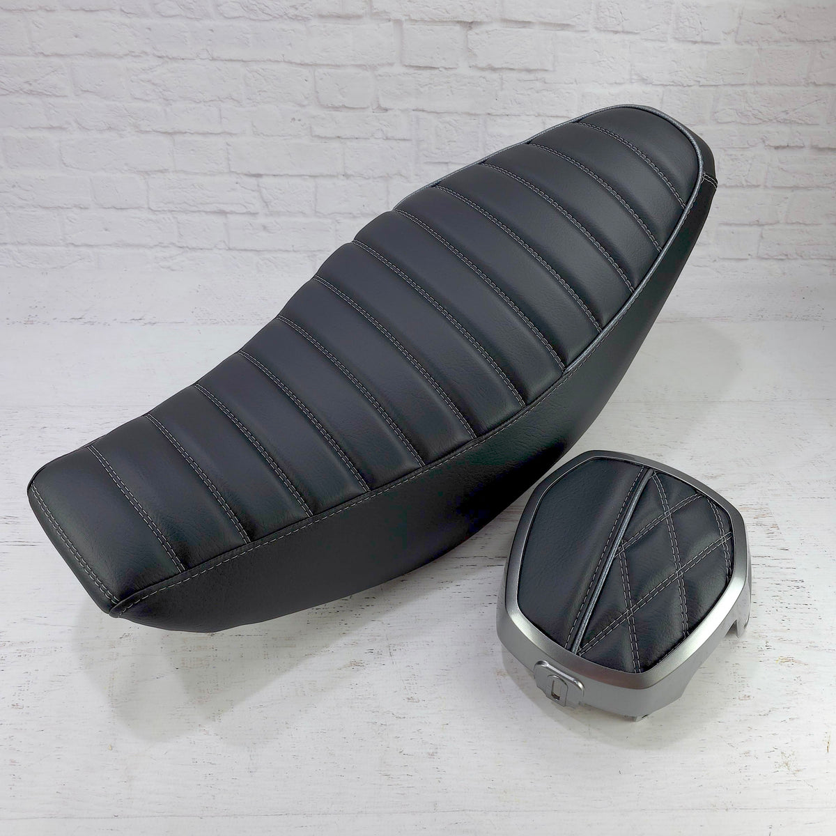 Honda Navi black tuck-and-roll seat cover with silver stitching and piping