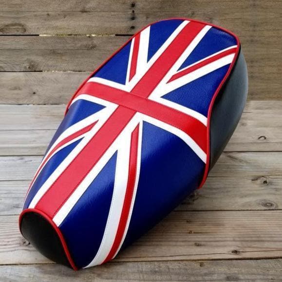 Front three-quarter view of a Union Jack Genuine Buddy Kick 125 seat cover with red piping and black sides, handmade by Cheeky Seats