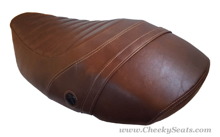 Rear angle of whiskey-brown Vespa S tuck-and-roll seat cover showing strap and lock opening by Cheeky Seats