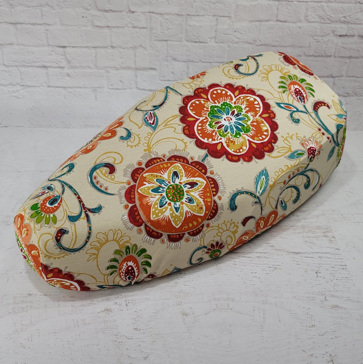 Ecru canvas Genuine Buddy Kick 125 seat cover with orange, teal, green and red floral medallions, handmade by Cheeky Seats