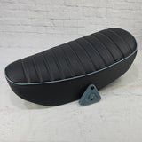 Black tuck-and-roll Honda DAX 125 seat cover with Pearl Gray stitching and piping with Honda mounting bracket as a color match swatch, handmade by Cheeky Seats