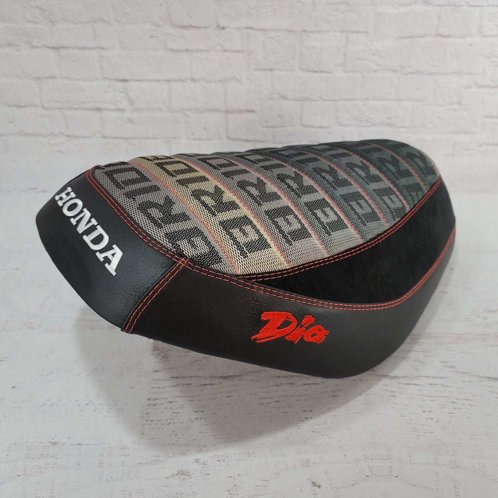 Side view Honda Dio Bride with Alcantara® Suede Seat Cover, with red stitching, and embroidered Dio logos - with a white embroidered Honda logo, handmade by Cheeky Seats
