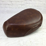 Front three-quarter view of a whiskey brown distressed leather-look Kymco People 50 seat cover with tan contrast stitching along the seam, handmade by Cheeky Seats