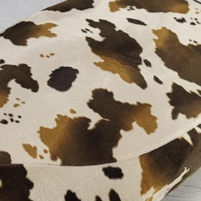 Brown-and-white cow-print faux-fur detail on a Cheeky Seats Genuine Buddy cover option