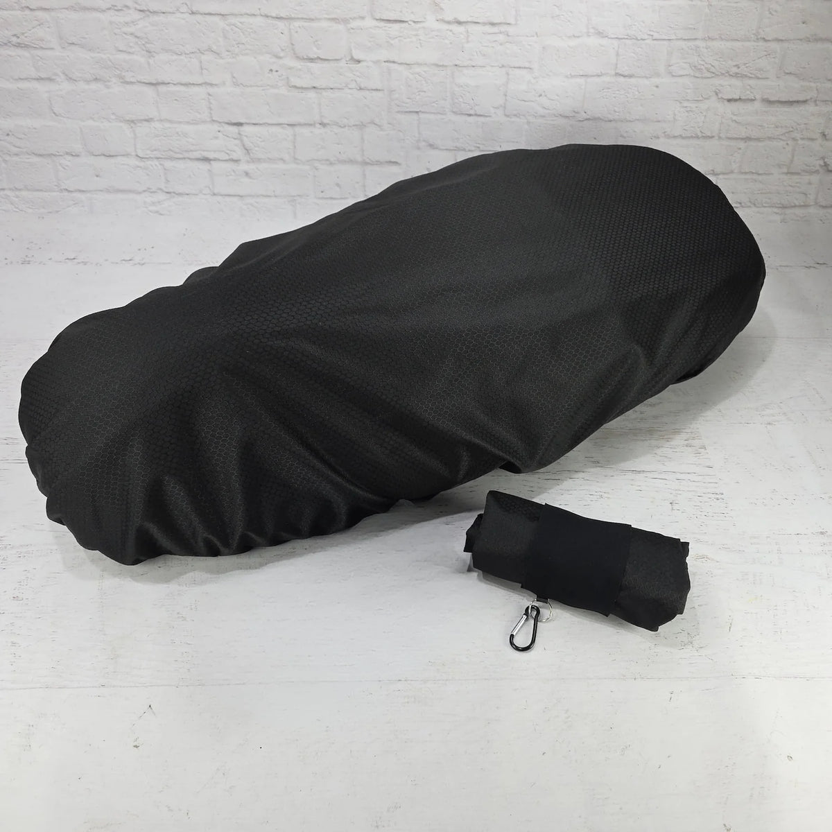 Vespa rain cover fitted on scooter seat