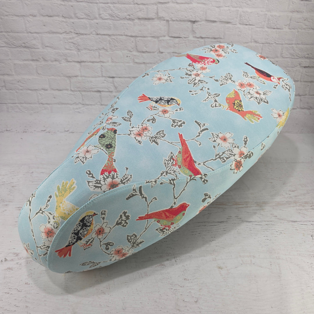 Stylized songbirds on branches on a robins egg blue background