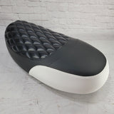 Front three-quarter view of a black Yamaha Zuma II BWS 49/50 Prebug seat cover with a padded diamond panel and white side accent, handmade by Cheeky Seats