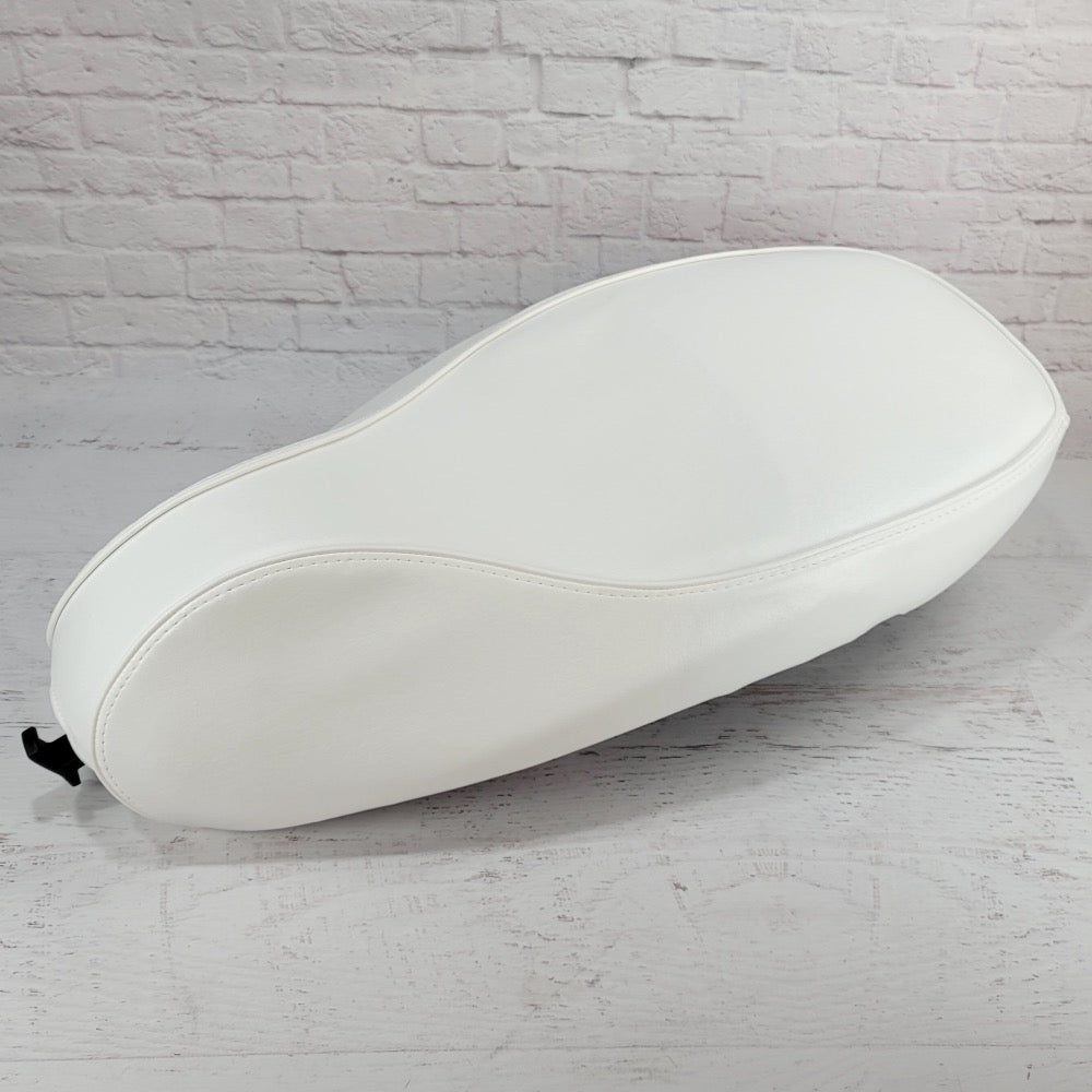 Side view of the Cottage White Vespa Sprint and Primavera seat cover showing full coverage and the bag-hook opening, handmade by Cheeky Seats.