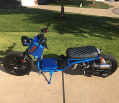Customer photo of a blue Maddog scooter on a driveway with Cheeky Seats black diamond seat cover installed