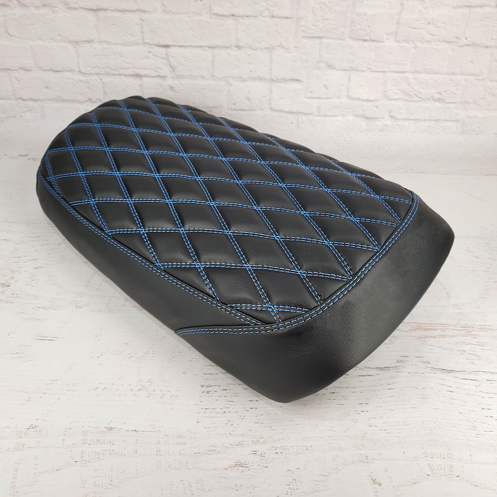Rear view of the matte black diamond seat cover showing blue contrast stitching detail, handmade by Cheeky Seats